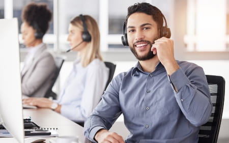Smiling man in headset - contact us!